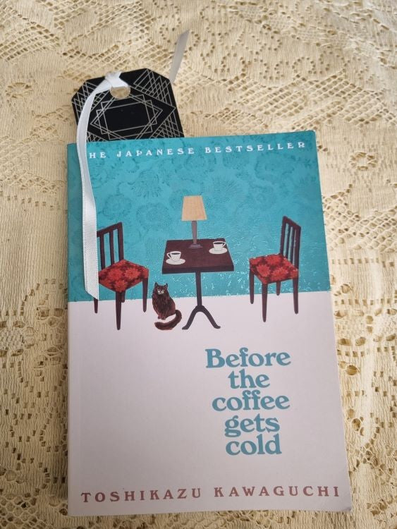 A bookmark of the Art Deco design Silver Frame inside a book