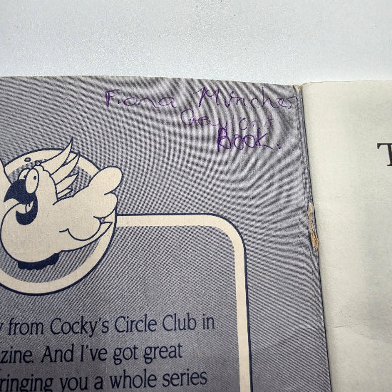 A close-up of a book page with handwriting on it.