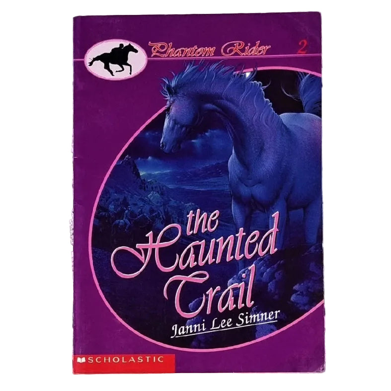 Paperback book cover of 'The Haunted Trail' featuring an illustration of a purple-colored horse on a dark background with a title and author name at the top.