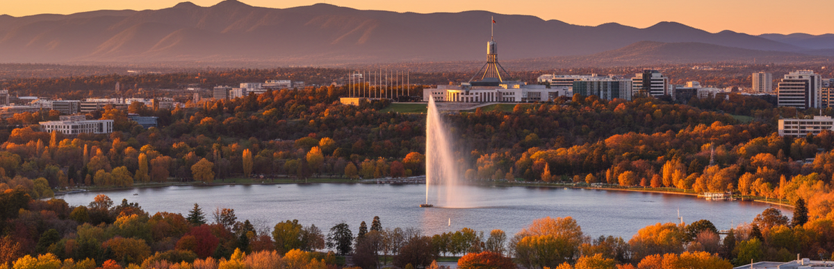 A scenic autumn landscape of Canberra showing Lake  Burley Griffin with the Captain James Cook Memorial Jet in action. Parliament House and the Mountains can be seen in the background.