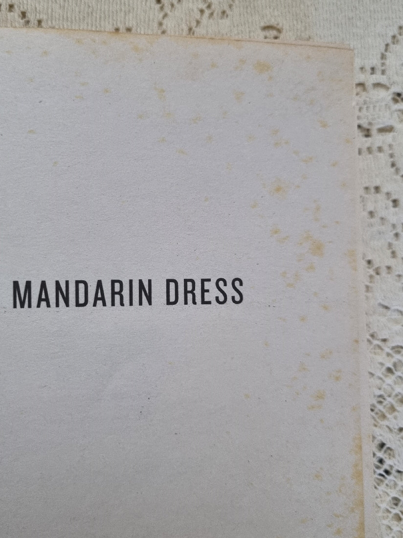 Example of foxing on Red Mandarin Dress by QIU XIAOLONG