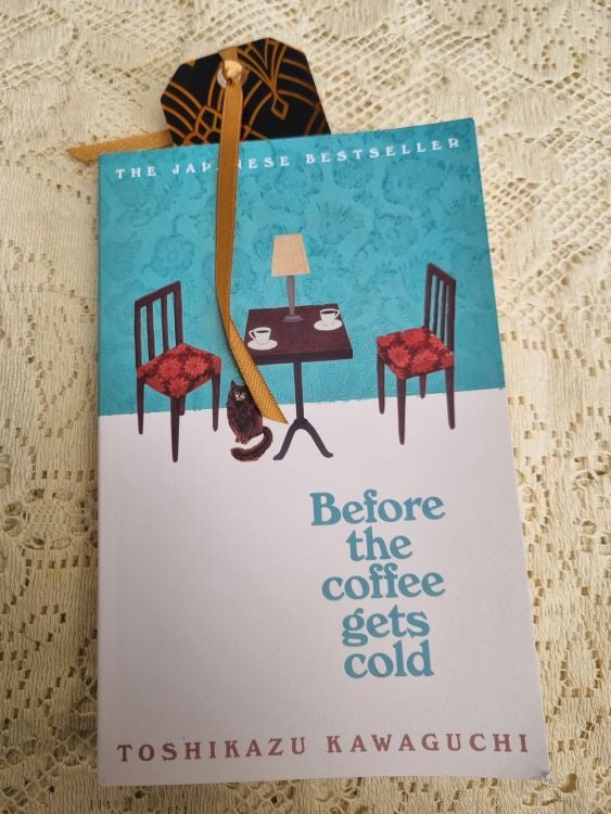 A bookmark of the Art Deco design Golden Fan inside a book