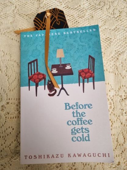 A bookmark of the Art Deco design Golden Fan inside a book