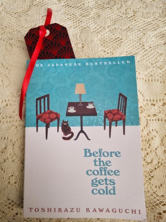 A bookmark of the Art Deco design Crimson Scallop inside a book