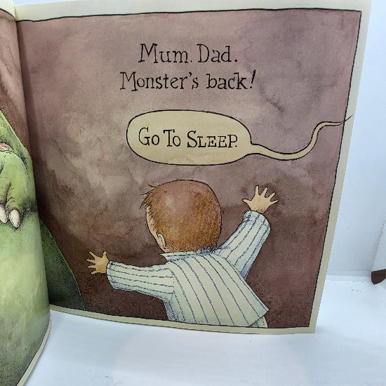 A children's picture book page showing an illustration of a baby in a striped pajama suit facing a monster, with the text 'Mum. Dad.