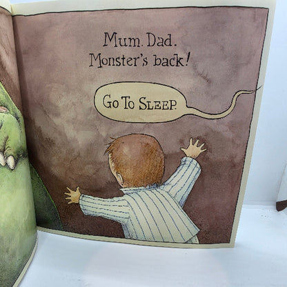 A children's picture book page showing an illustration of a baby in a striped pajama suit facing a monster, with the text 'Mum. Dad.