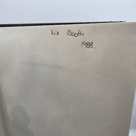 A close-up of a handwritten inscription in the book. 
