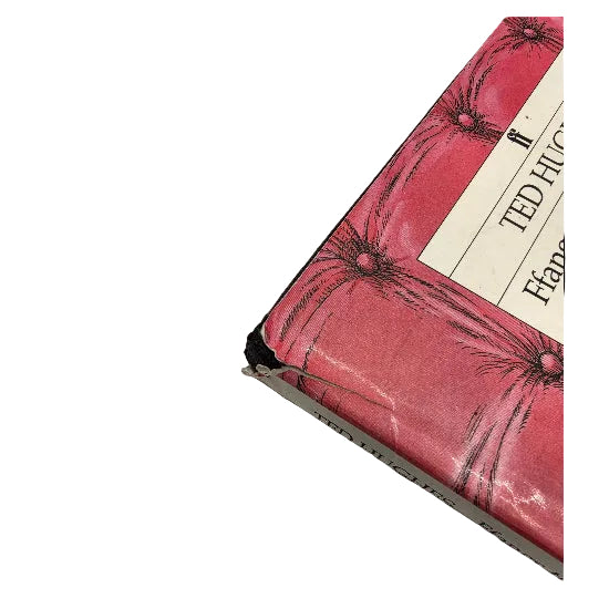 A close-up of a  hardcover book showing a damaged corner.  