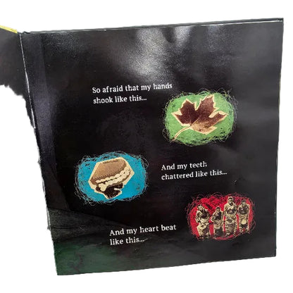 An open children's book showing a dark illustrated page with three small drawings and printed text. The page has a black background and colourful accents in green, blue, brown, beige, and red.