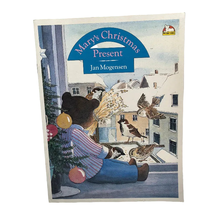 A vintage children's book titled 'Mary's Christmas Present' by Jan Mogensen, featuring a colorful illustration of a bear in winter clothing with birds and a snowy town scene.
