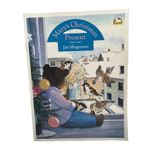 A vintage children's book titled 'Mary's Christmas Present' by Jan Mogensen, featuring a colorful illustration of a bear in winter clothing with birds and a snowy town scene.