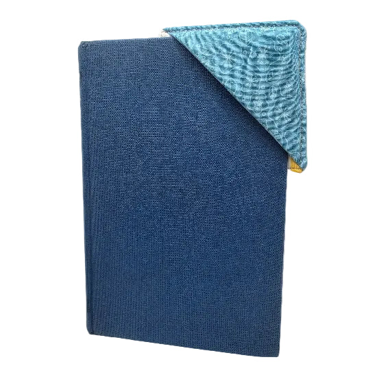 A blue hardcover book with a patchwork bookmark over it's corner