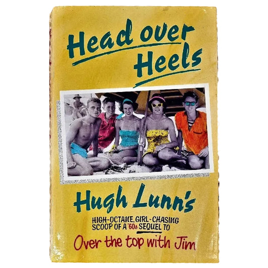 The cover of the book 'Head Over Heels' by Hugh Lunn features a group photograph of the author with friends. The book is a biography with a focus on the author's life.