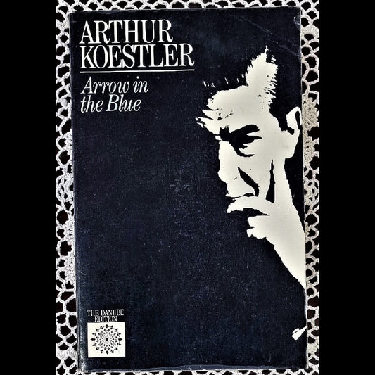 A paperback book titled 'Arrow in the Blue' by Koestler, featuring a black and white cover image of a man with a contemplative expression.