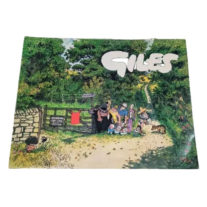 Front cover of Giles cartoons featuring a colourful cartoon illustration of a group of children and a dog near a gate in a wooded path, with the word 'GILES' in large white letters at the top. 