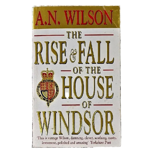 The cover of the book 'The Rise and Fall of the House of Windsor' features a white background with gold text and a red and blue Windsor family crest in the center.