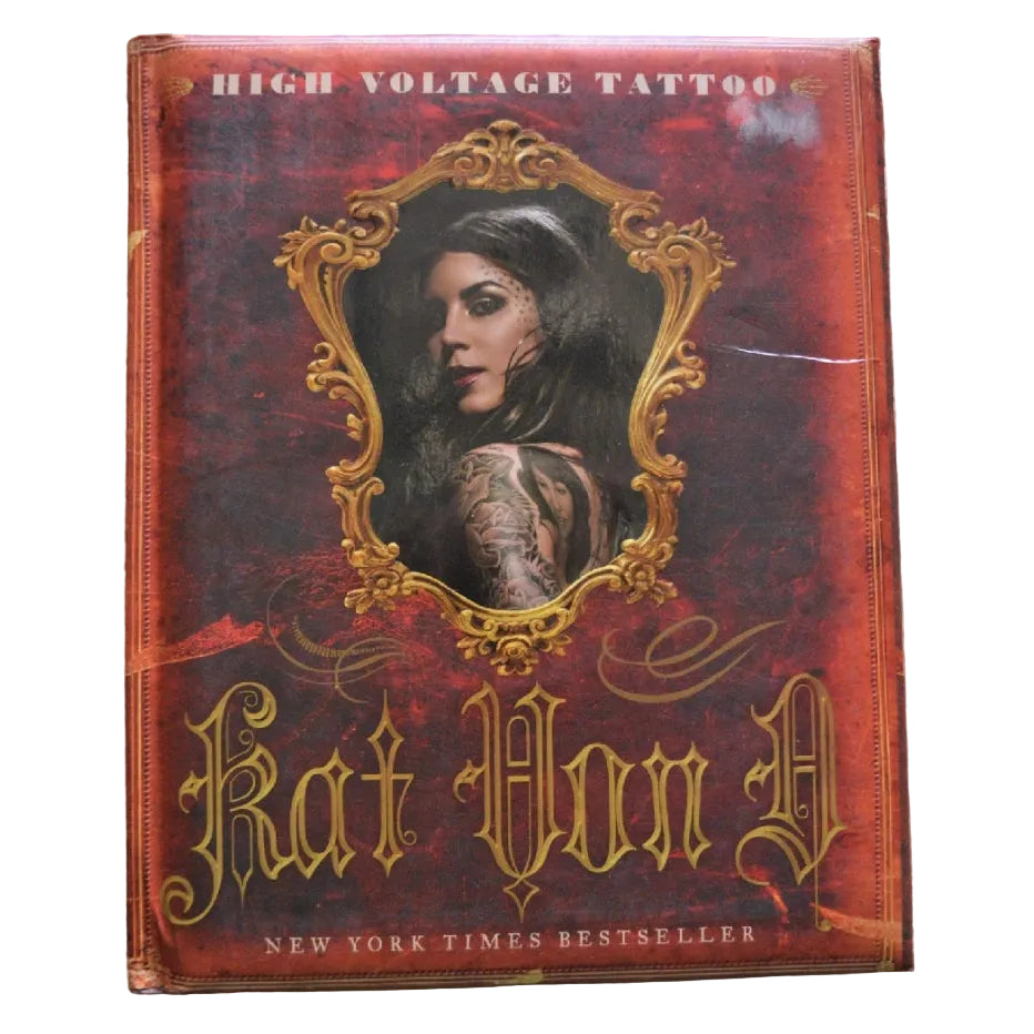 The book cover of 'High Voltage Tattoo' by Kat Von D, featuring a gothic red and gold design with an ornate portrait of a tattooed woman, displayed on a textured cream lace background.