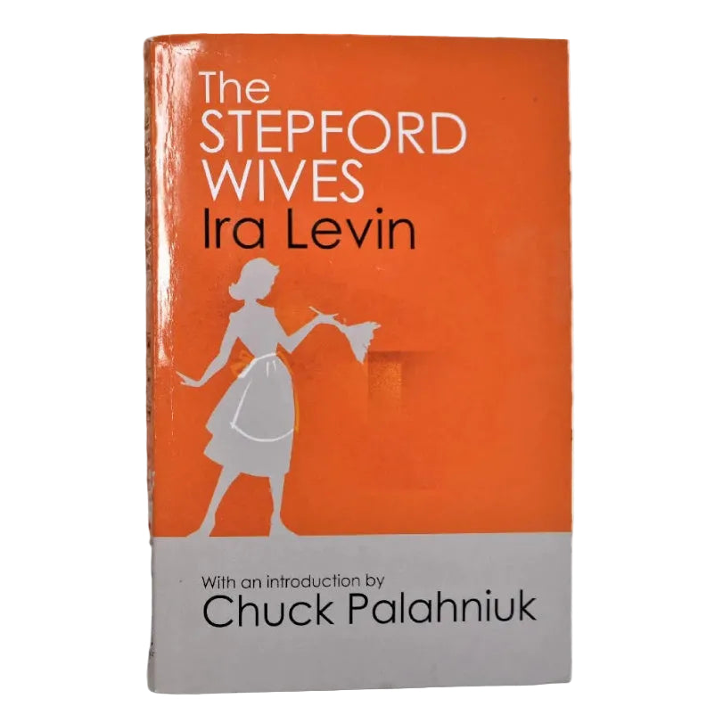 The front cover of the book 'The Stepford Wives' by Ira Levin, featuring a bright orange top section with white and black text and a gray silhouette of a woman, and a light gray bottom section 'With an introduction by Chuck Palahniuk'.
