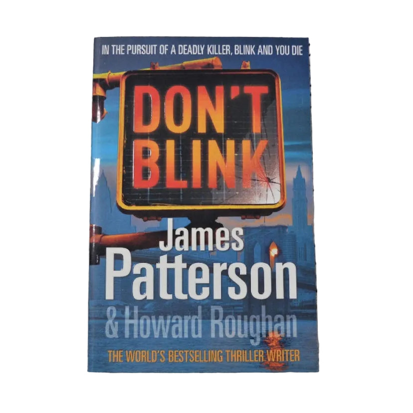Paperback book cover of 'Don't Blink' by James Patterson and Howard Roughan, featuring a traffic sign with the phrase 'DON'T BLINK'.