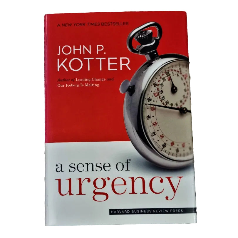 Book cover of 'A Sense of Urgency' by John P. Kotter, featuring a red upper section, a white lower section, and a large pocket watch graphic on the right.