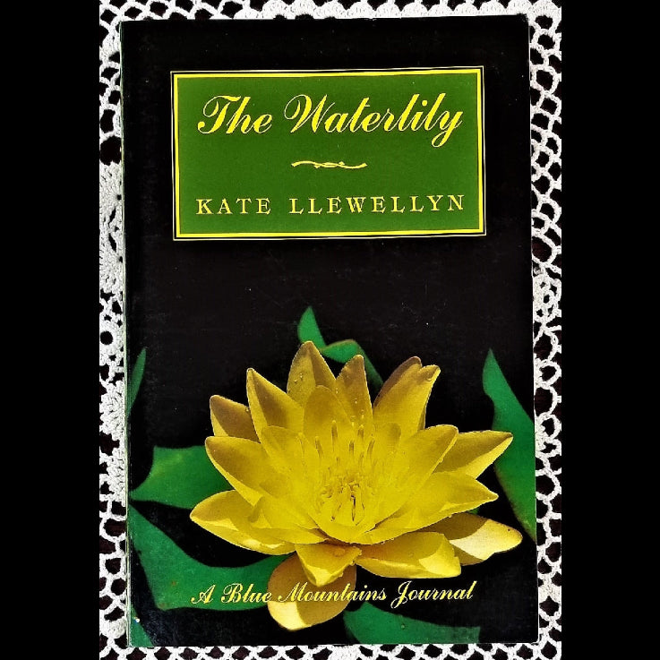 A journal cover for 'The Waterlily' by Kate Llewellyn, featuring a yellow waterlily flower on a black background with a green title panel.