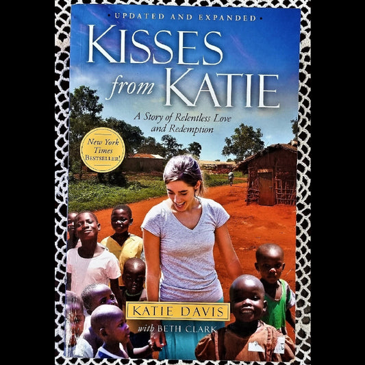 The cover of the book 'Kisses From Katie' features a woman with a group of children in a rural setting, indicating a story set in Uganda.