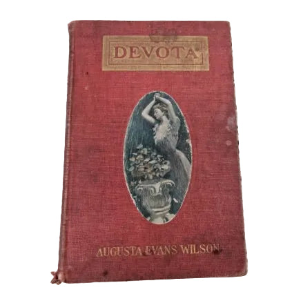 A red hardcover book titled 'DEVOTA' with a colour illustration inset.